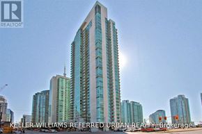 Toronto (Waterfront Communities) condo for rent - A tall building with a glass facade is the main focus of the image.
