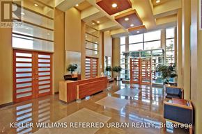 Toronto (Waterfront Communities) condo for rent - A lobby with a reception desk and a large window.