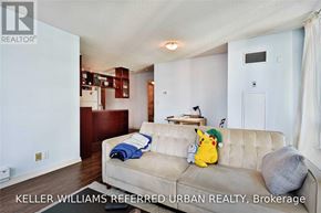 Toronto (Waterfront Communities) condo for rent - A living room with a couch and a small table with a lamp.