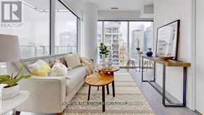 Toronto (Church-Yonge Corridor) condo for rent - A living room with a couch, coffee table, and a view of the city.