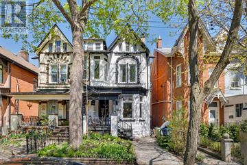 Toronto (Palmerston-Little Italy) apartment for rent - A Victorian style house with a front porch and a tree in front.