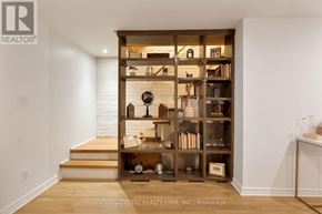 Toronto (Palmerston-Little Italy) apartment for rent - A wooden bookshelf filled with various items sits in the corner of a room.