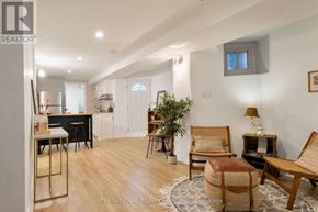 Toronto (Palmerston-Little Italy) apartment for rent - A well-lit, spacious living room with a dining area in the background.