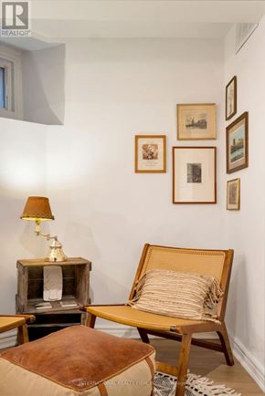 Toronto (Palmerston-Little Italy) apartment for rent - A living room with a chair, ottoman, and pictures on the wall.