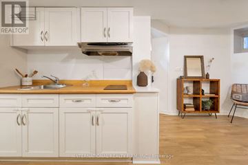 Toronto (Palmerston-Little Italy) apartment for rent - A kitchen with white cabinets and a wooden countertop.