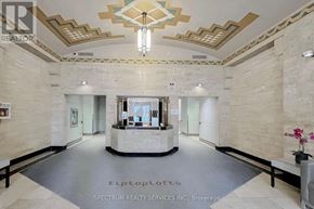 Toronto (Niagara) condo for rent - A reception area with a chandelier and a sign for Spectrum Realty Services Inc.