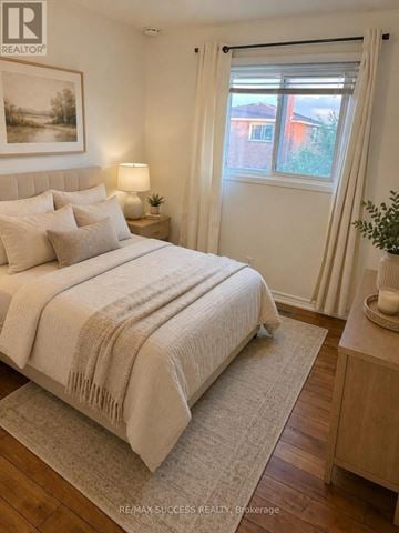 Brampton (Brampton West) apartment for rent - A bedroom with a large bed and a window with curtains.