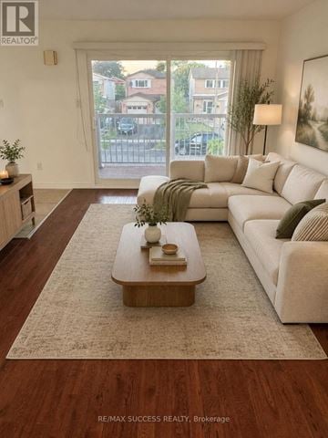 Brampton (Brampton West) apartment for rent - A living room with a white couch and a coffee table in front of a large window.