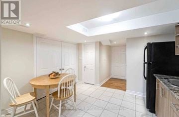 Brampton (Bram East) apartment for rent - A kitchen with a table and chairs in the foreground and a refrigerator in the background.