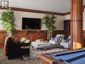 Smiths Falls condo for rent - A living room with a pool table and a television.