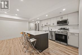 Ottawa apartment for rent - A modern kitchen with wooden flooring and stainless steel appliances.