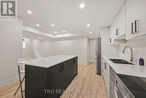 Ottawa apartment for rent - A modern kitchen with a white countertop and black cabinets.