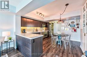 Toronto (Clanton Park) condo for rent - A modern kitchen with a wooden island and a dining table set up.