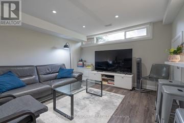 Richmond Hill (Crosby) apartment for rent - A living room with a grey sofa and a glass coffee table.