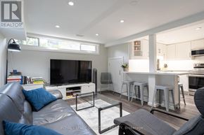 Richmond Hill (Crosby) apartment for rent - A living room with a grey couch and a television.