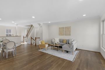 Baltimore apartment for rent - A living room with a grey couch and a yellow chair.