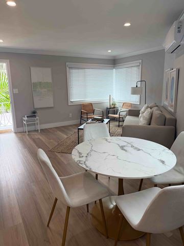 Coronado apartment for rent - A modern living room with a white marble table and white chairs.
