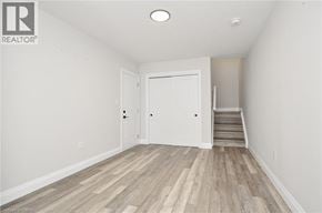 Cambridge townhouse for rent - A room with a white door and wooden flooring.