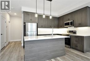 Cambridge townhouse for rent - A modern kitchen with a large island and stainless steel appliances.