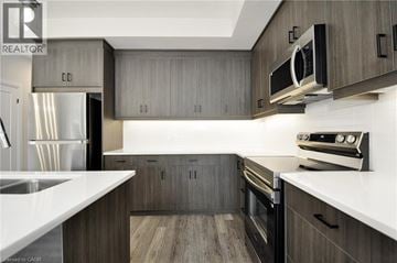 Cambridge townhouse for rent - A modern kitchen with wooden cabinets and stainless steel appliances.