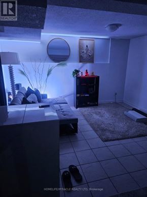Brampton (Downtown Brampton) apartment for rent - A living room with a couch, a coffee table, and a rug.