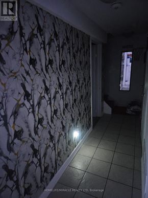 Brampton (Downtown Brampton) apartment for rent - A hallway with a wallpapered wall and a light on.
