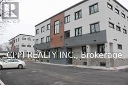 Port Colborne (Main Street) townhouse for rent - A white car is parked in front of a building.