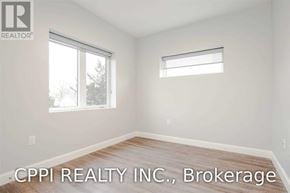 Port Colborne (Main Street) townhouse for rent - A room with a window and a wooden floor.
