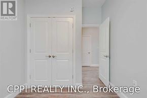 Port Colborne (Main Street) townhouse for rent - A white door with a handle and a small light on the wall above it.