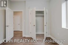 Port Colborne (Main Street) townhouse for rent - A real estate image of a room with white walls and a doorway leading to another room.