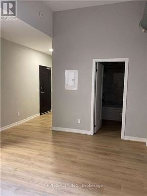 Peterborough (Town Ward 3) condo for rent - A room with a wooden floor and a white wall with a switchboard.