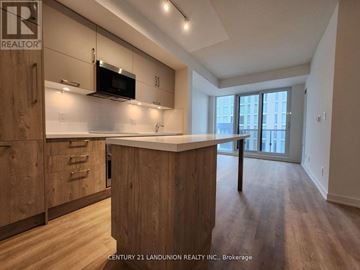 Markham (Unionville) condo for rent - A kitchen with wooden cabinets and a counter top.