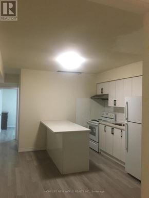 Toronto (Greenwood-Coxwell) apartment for rent - A kitchen with white appliances and a white island.