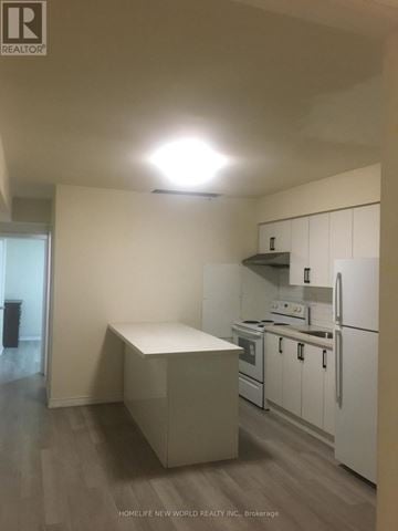 Toronto (Greenwood-Coxwell) apartment for rent - A kitchen with white appliances and a white island.