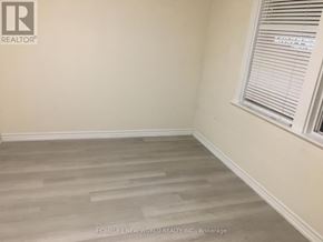 Toronto (Greenwood-Coxwell) apartment for rent - A room with a window and wooden flooring.