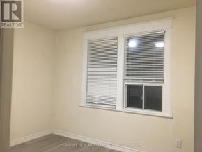 Toronto (Greenwood-Coxwell) apartment for rent - A room with a window covered in blinds.