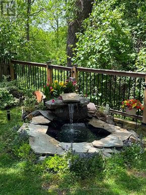 Markham (Thornlea) apartment for rent - A small waterfall in a garden surrounded by a fence.
