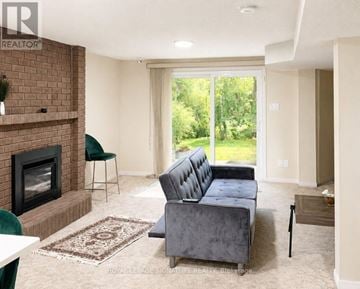 Markham (Thornlea) apartment for rent - A living room with a grey couch and a fireplace.