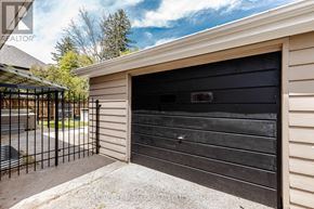 Oakville (Wo West) apartment for rent - A black garage door is closed and there is a gate in front of it.