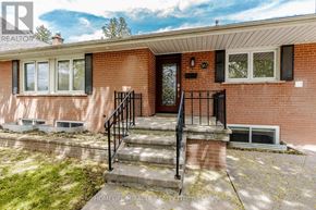 Oakville (Wo West) apartment for rent - A red brick house with a black metal railing on the steps.