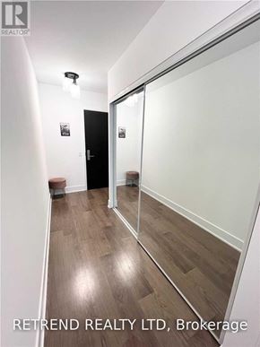 Toronto (Church-Yonge Corridor) condo for rent - A hallway with wood flooring and white walls.