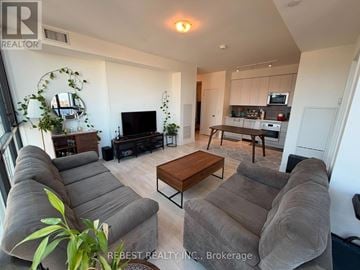 Vaughan (Concord) condo for rent - A living room with a grey couch and a wooden coffee table.