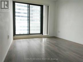 Toronto (Church-Yonge Corridor) condo for rent - A room with a large window and wooden flooring.