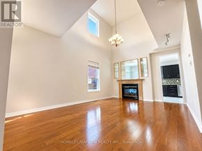 Richmond Hill (Oak Ridges Lake Wilcox) apartment for rent - A spacious living room with wood flooring and a fireplace.