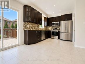 Richmond Hill (Oak Ridges Lake Wilcox) apartment for rent - A modern kitchen with dark brown cabinets and stainless steel appliances.