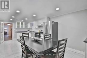 Toronto (York University Heights) apartment for rent - A kitchen with a table and chairs in the foreground and a refrigerator in the background.