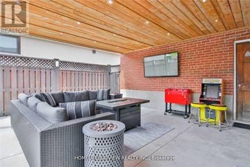 Toronto (York University Heights) apartment for rent - A living room with a grey couch and a red chair.