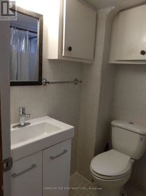 Toronto (Weston) apartment for rent - A white toilet sits next to a sink in a small bathroom.