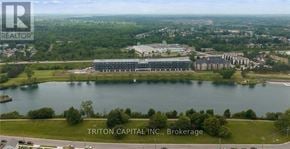 Welland (Broadway) condo for rent - A brokerage company logo is on an aerial shot of a lakefront property.