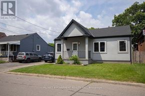 Hamilton (Homeside) apartment for rent - A house with a grey roof and a sign that says REALTOR.